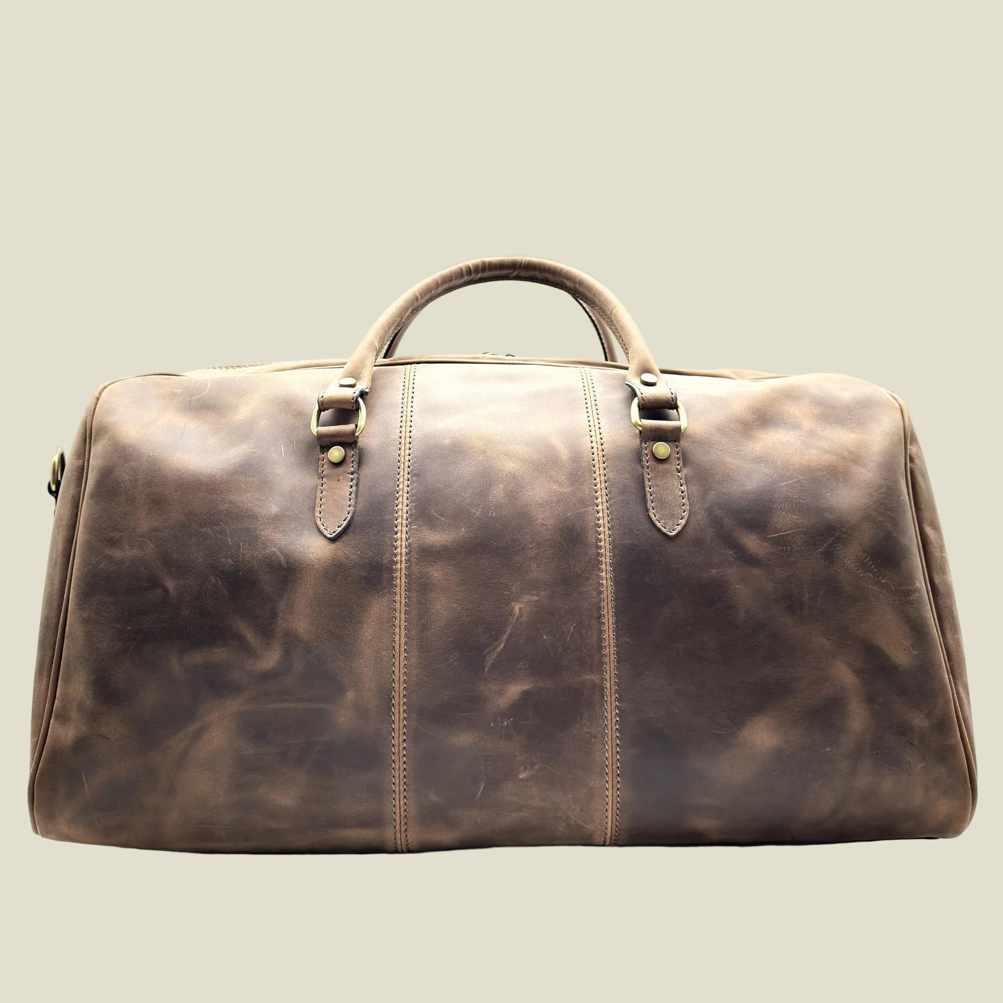 A distressed brown leather duffel bag with dual top handles and brass-tone hardware, photographed against a plain white background.