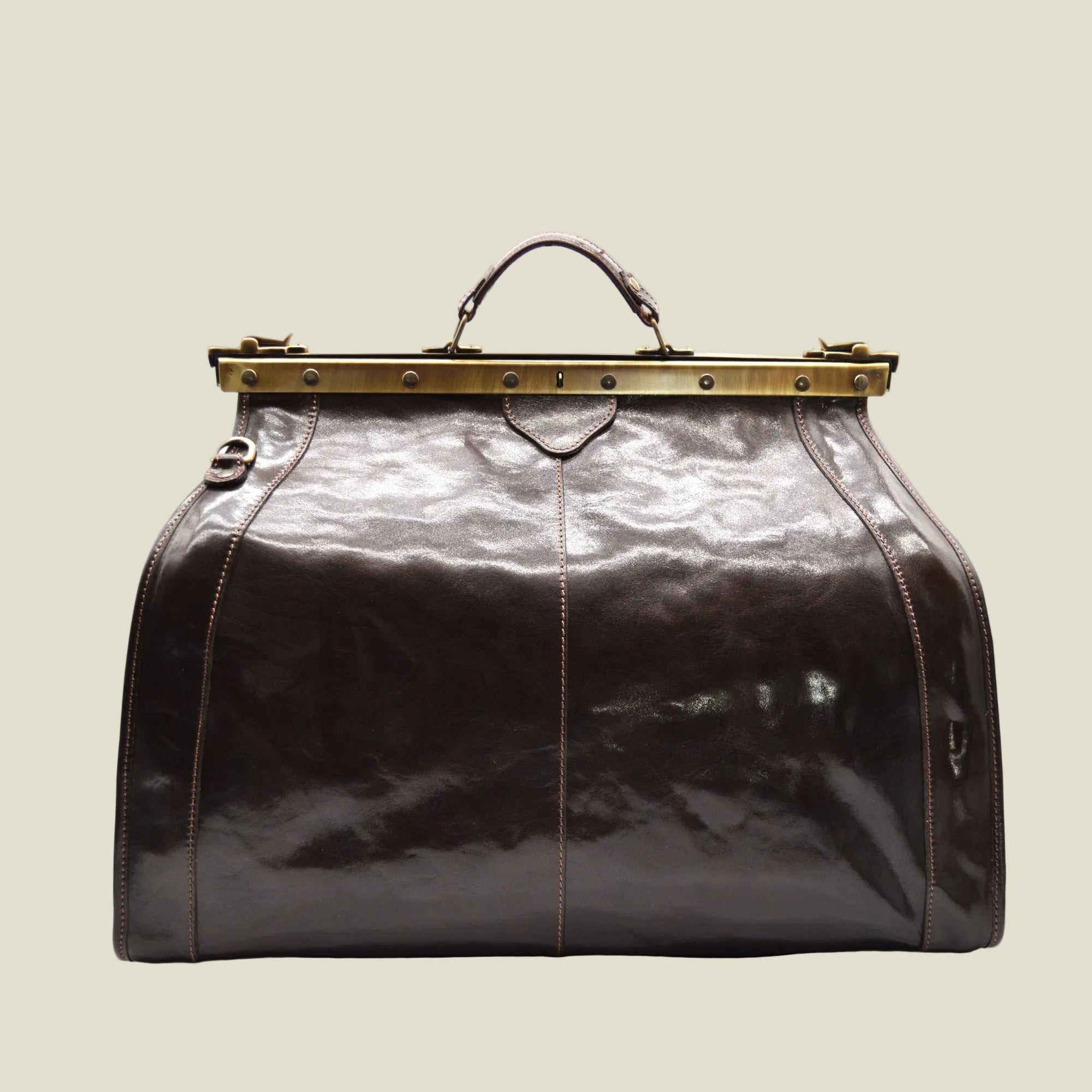 A dark brown glossy leather duffel bag with a brass-tone metal frame handle closure, shown against a plain white background.