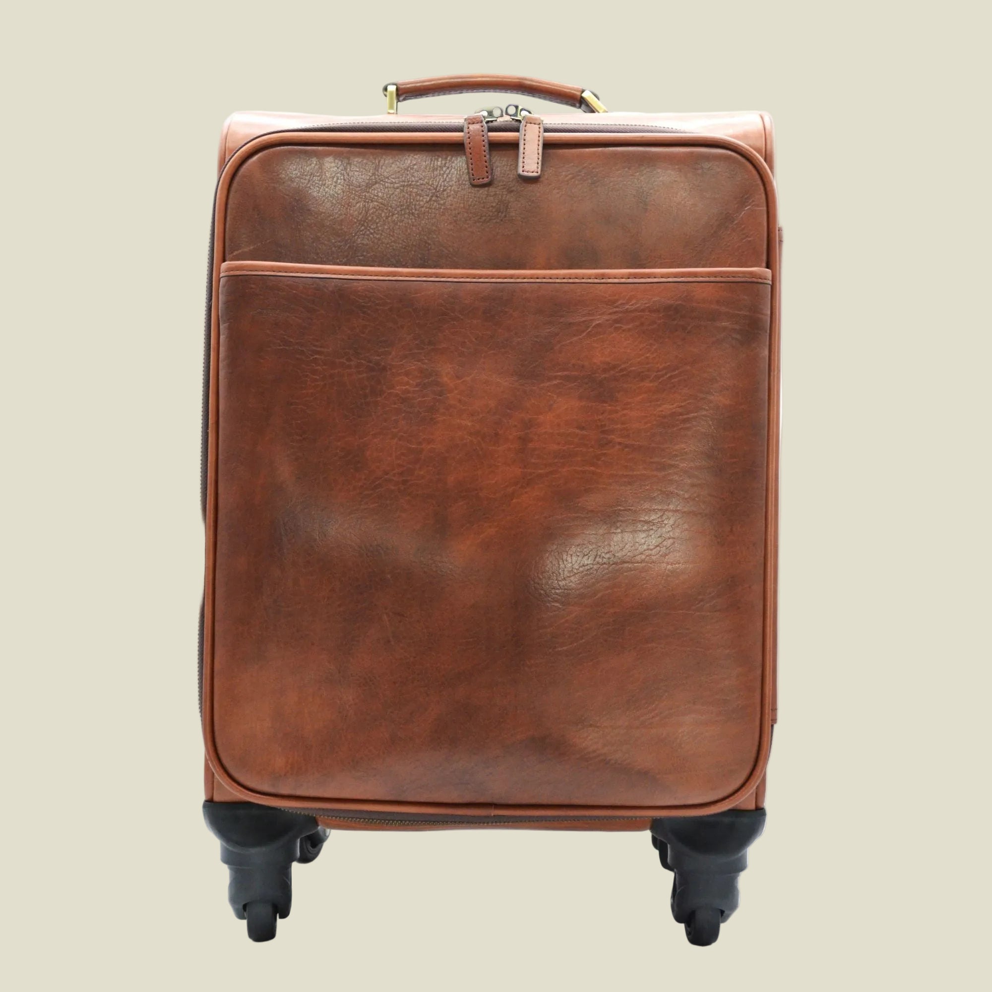 A brown leather rolling suitcase with a front zippered pocket and black spinner wheels, shown against a plain white background.