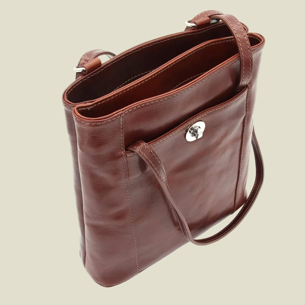 A brown leather shoulder bag with a silver-tone metal clasp, shown from an overhead angle on a white background.
