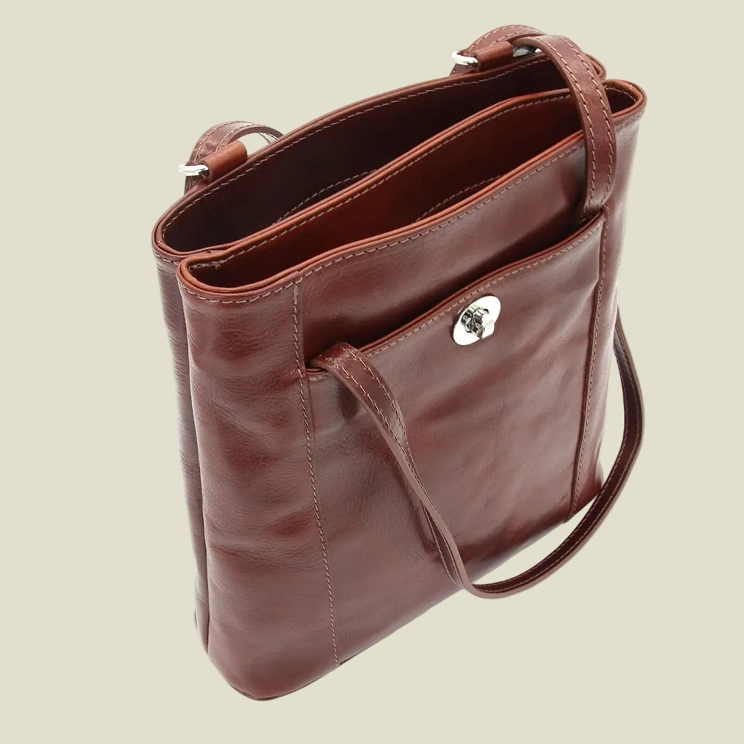 A brown leather shoulder bag with a silver-tone metal clasp, shown from an overhead angle on a white background.