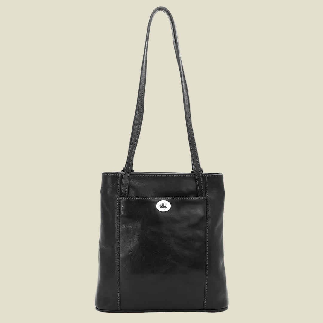 A black leather tote bag with a single shoulder strap and a small silver-tone logo medallion on the front pocket, shown against a plain white background.