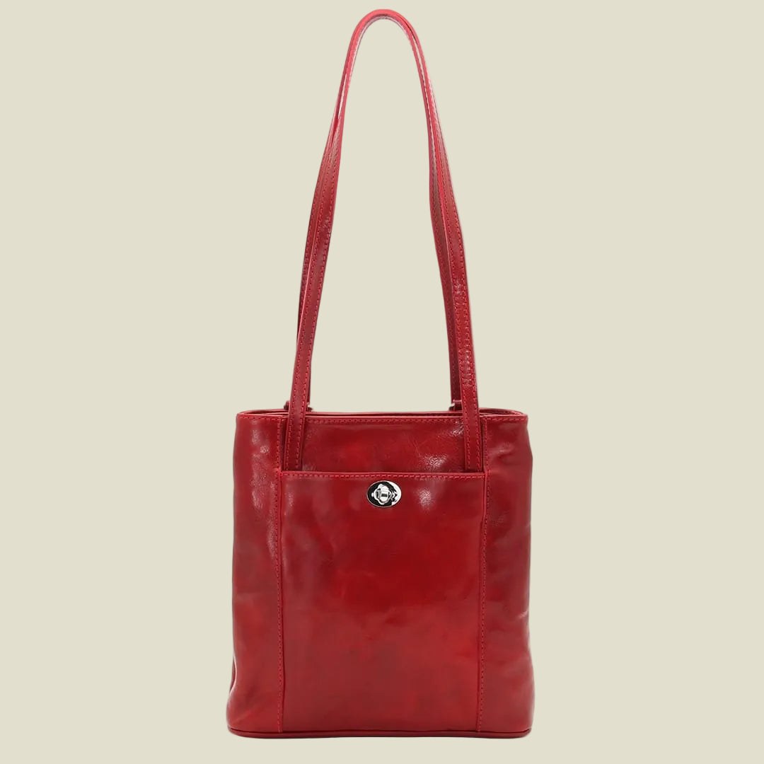 A red leather tote bag with a front pocket and a small silver-tone logo clasp, shown against a plain white background.