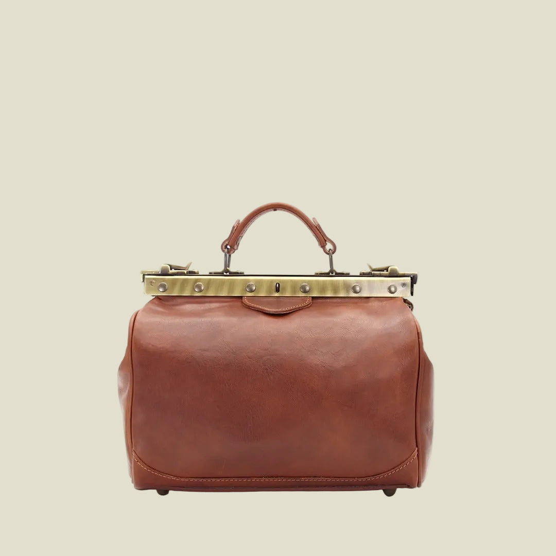 A brown leather doctor-style handbag with a top handle, a brass-tone metal frame, and rivets, shown against a plain white background.