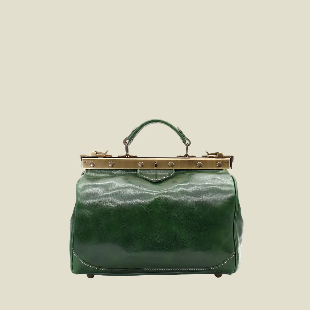 A green leather handbag with a top handle, a gold-tone metal frame clasp, and a wavy texture, shown against a plain white background.