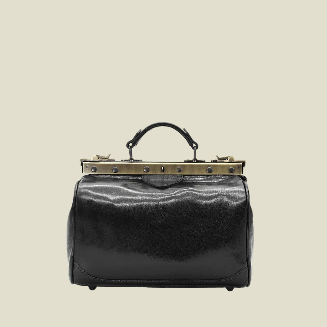 A black leather handbag with a structured, rounded rectangular body, a top handle, and a prominent antique bronze metal frame clasp at the top, shown against a plain white background.