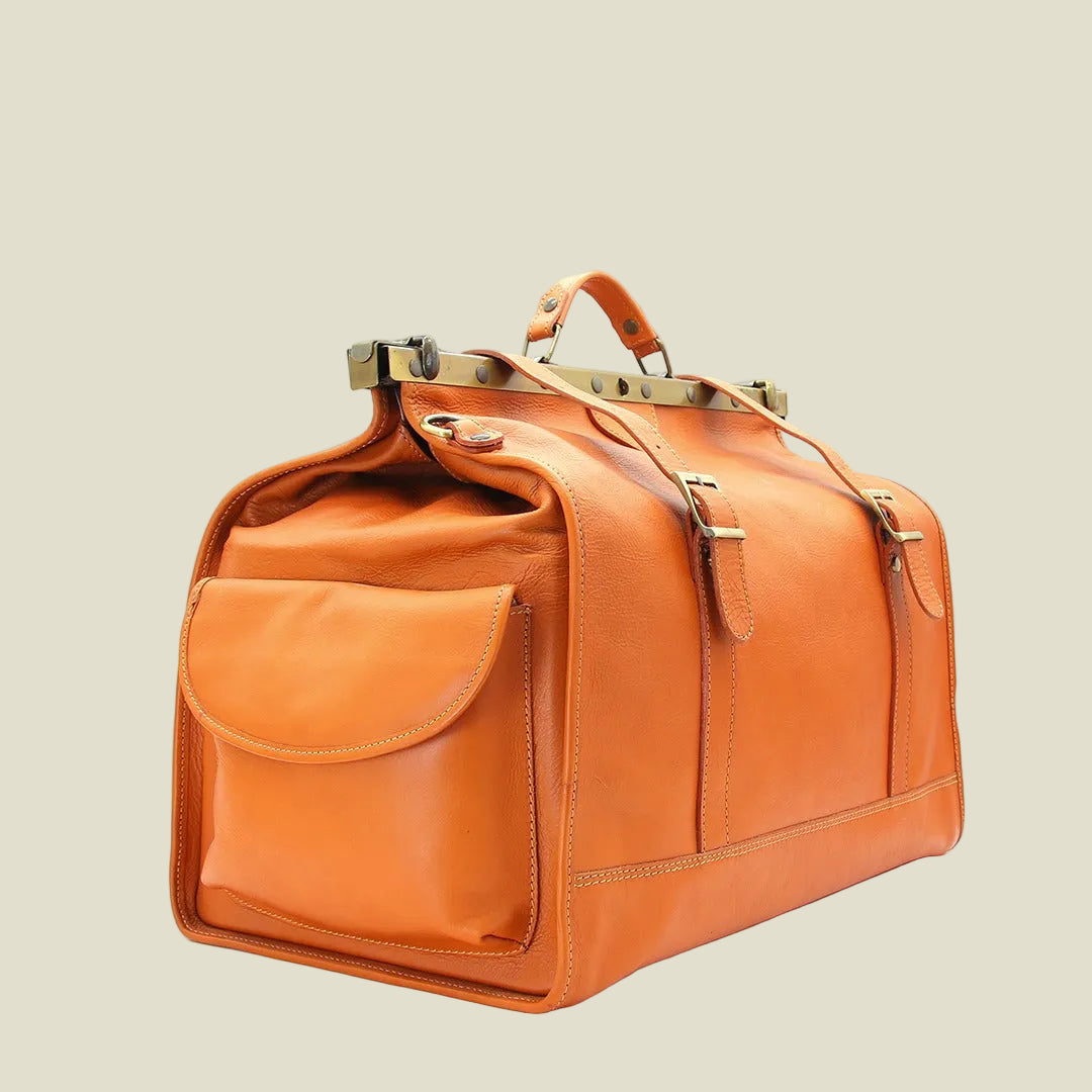 Orange leather duffel bag with gold accents on a white background