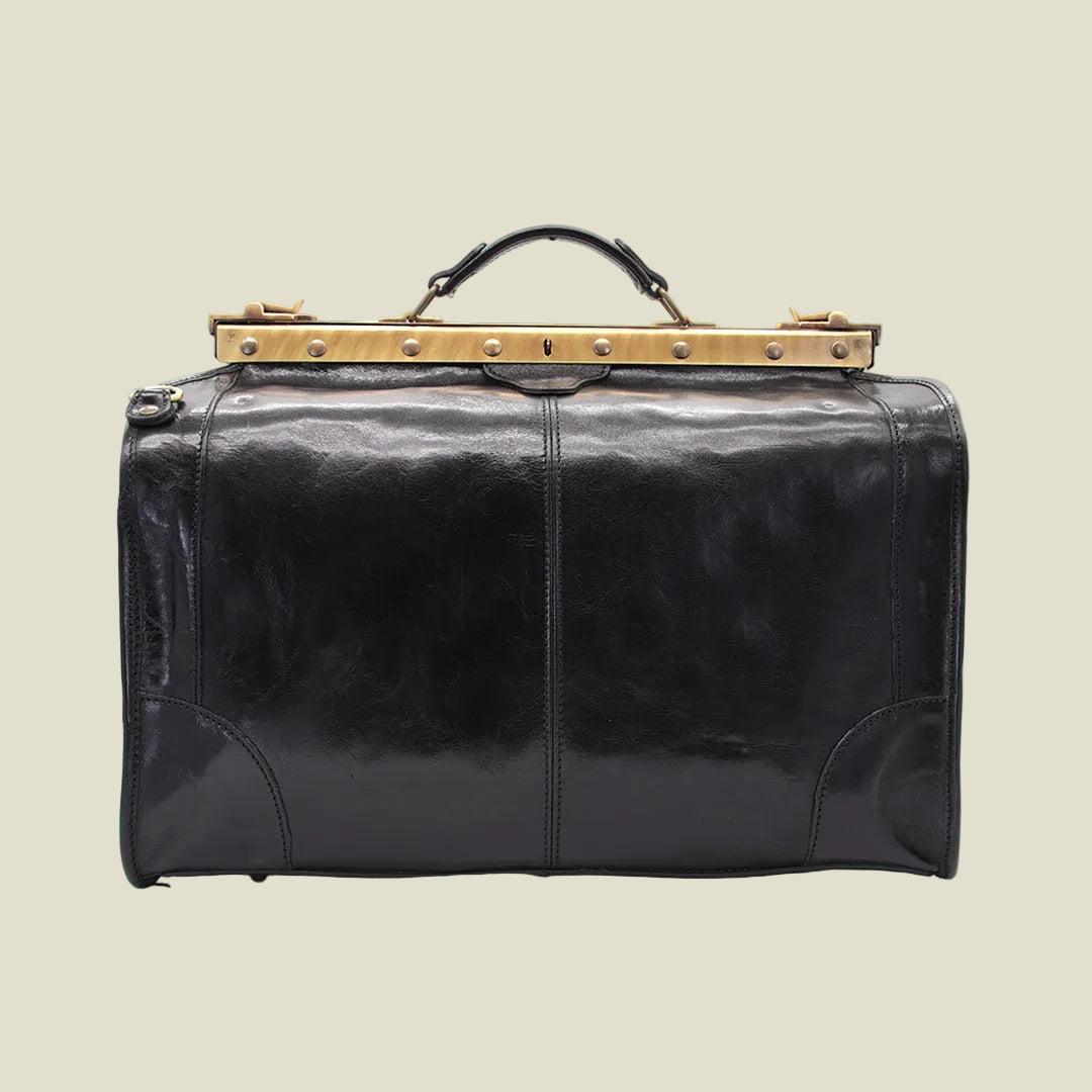 A black leather duffel bag with a prominent gold-tone metal frame and handle, photographed against a plain white background.