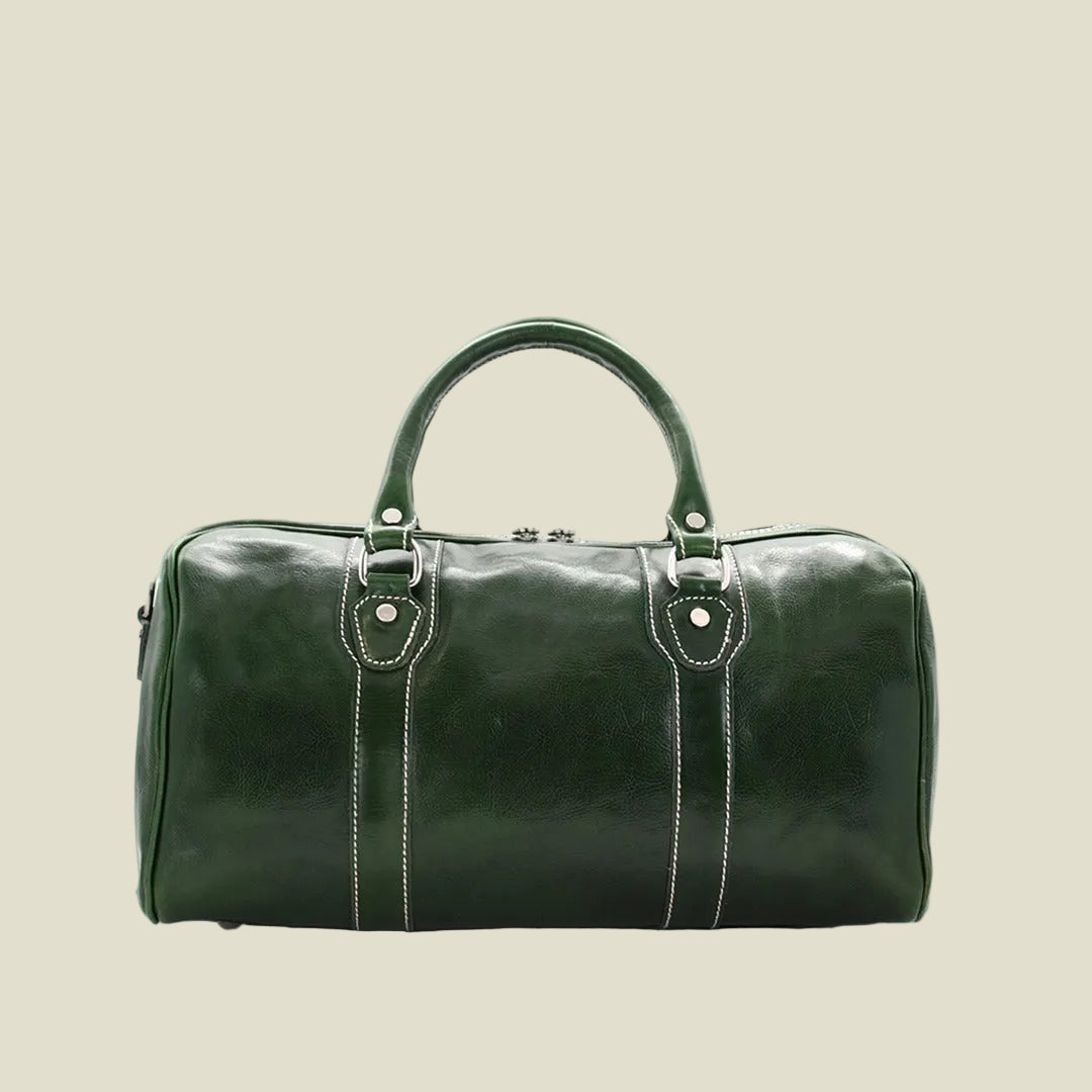 A dark green leather duffel bag with silver-tone hardware and white contrast stitching, shown against a plain white background.