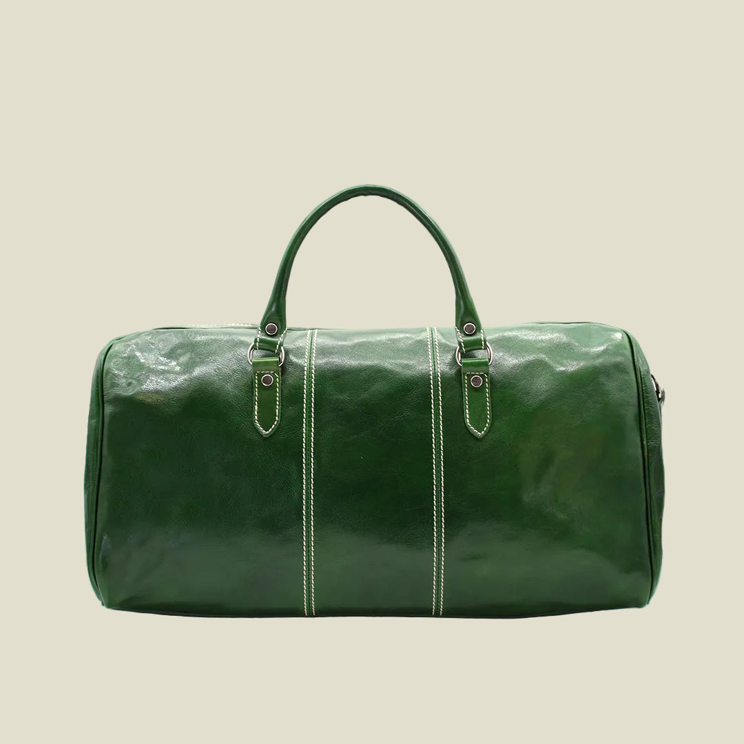 A dark green leather duffel bag with double top handles, decorative light green contrast stitching, and silver-tone hardware, shown against a plain white background.